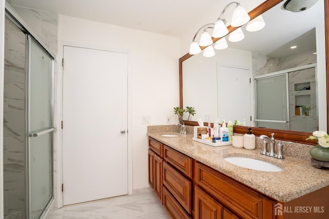 bathroom featuring vanity, a shower with shower door, and an inviting chandelier