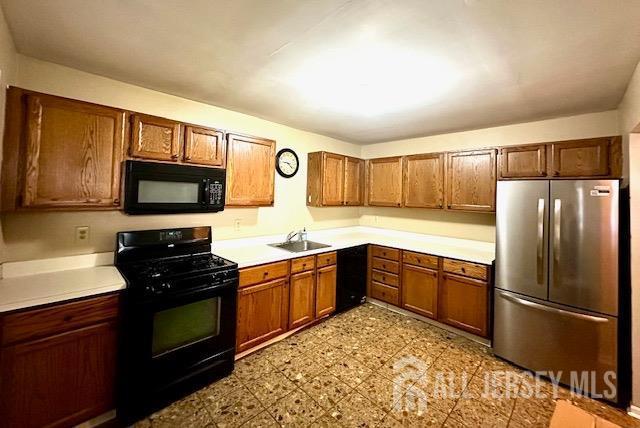 kitchen featuring black appliances and sink