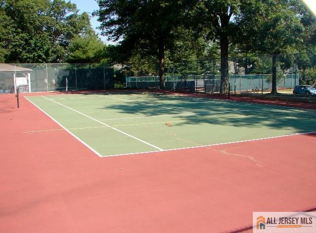 view of tennis court with fence