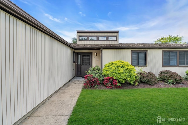 218 Community Cir, Old Bridge, NJ 08857 - property entrance with a lawn and roof with shingles