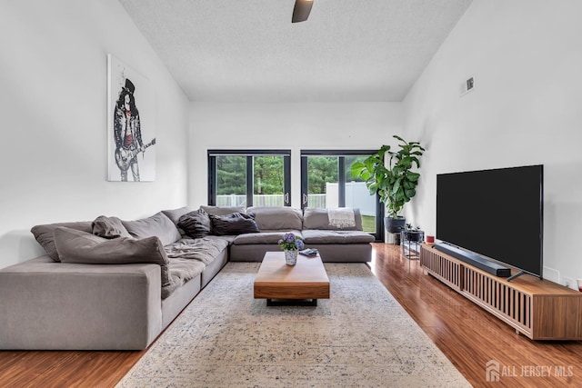 218 Community Cir, Old Bridge, NJ 08857 - living room featuring wood finished floors, ceiling fan, and a textured ceiling