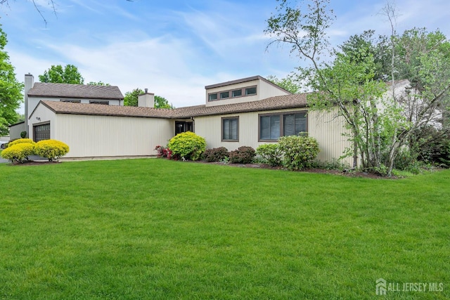 218 Community Cir, Old Bridge, NJ 08857 - view of front of house featuring a chimney, a front lawn, a garage, and a shingled roof