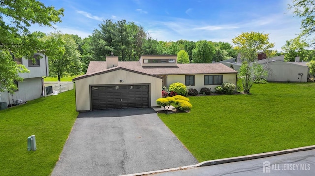 218 Community Cir, Old Bridge, NJ 08857 - view of front of property featuring a front yard, driveway, an attached garage, and roof with shingles