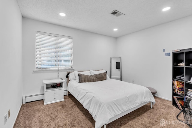 218 Community Cir, Old Bridge, NJ 08857 - carpeted bedroom with baseboard heating, recessed lighting, a textured ceiling, and baseboards
