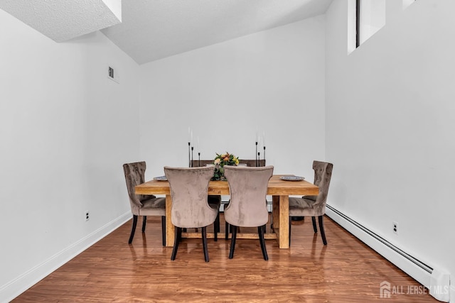 218 Community Cir, Old Bridge, NJ 08857 - dining area with baseboard heating, wood finished floors, and baseboards