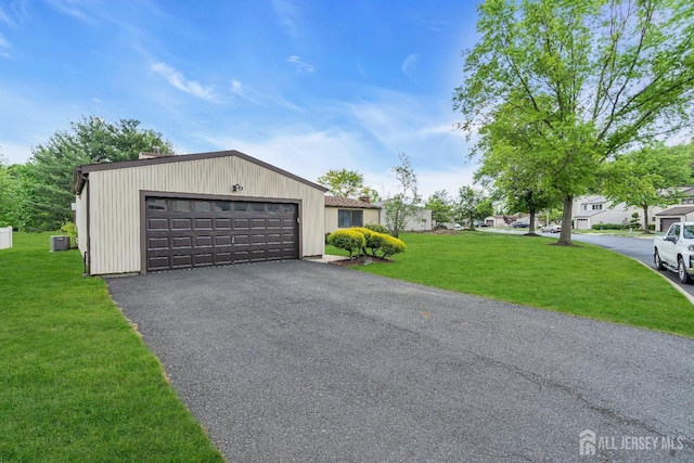 218 Community Cir, Old Bridge, NJ 08857 - view of front facade featuring a front lawn, a garage, asphalt driveway, and central AC