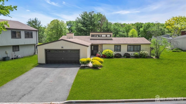 218 Community Cir, Old Bridge, NJ 08857 - view of front of property with a garage, asphalt driveway, a front yard, and roof with shingles