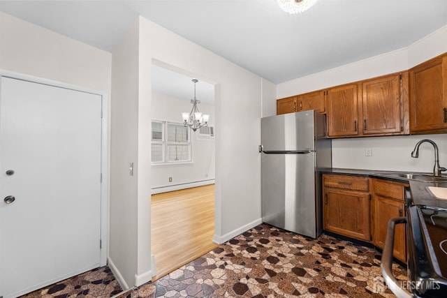82 Mercer St, Menlo Park Terrace, NJ 08840 - kitchen featuring freestanding refrigerator, a baseboard heating unit, brown cabinets, dark countertops, and a chandelier
