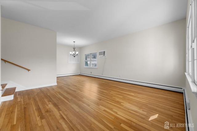 82 Mercer St, Menlo Park Terrace, NJ 08840 - spare room with a chandelier, light wood finished floors, a wall mounted AC, and a baseboard heating unit
