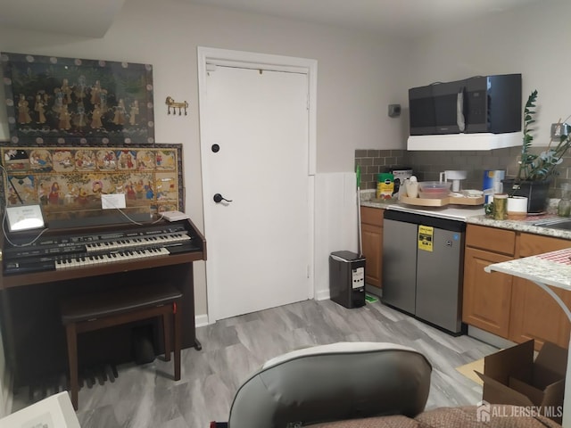 kitchen with refrigerator, light countertops, decorative backsplash, brown cabinetry, and dishwashing machine