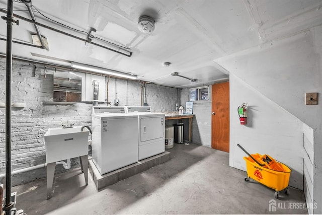 unfinished basement featuring washing machine and dryer and a sink