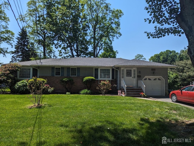 ranch-style home featuring a garage, concrete driveway, a front lawn, and brick siding