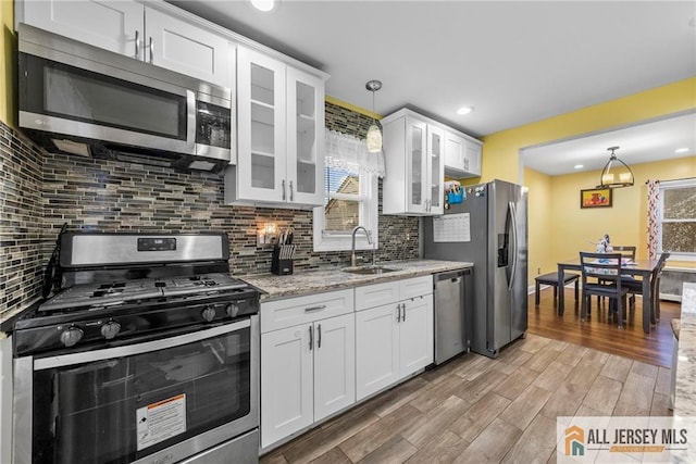 43 Livingston Ave, Avenel, NJ 07001 - kitchen featuring white cabinets, stainless steel appliances, light wood-style flooring, and a sink