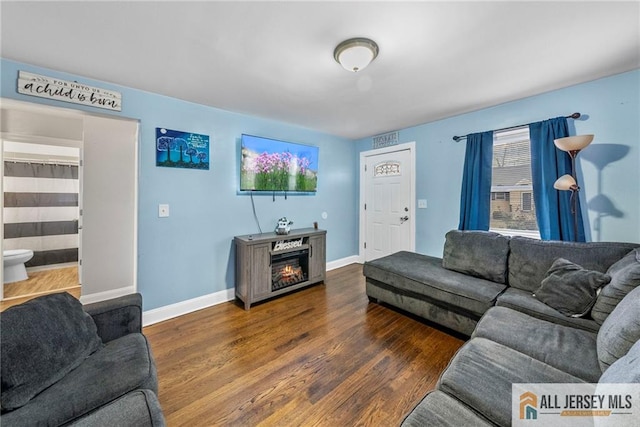 43 Livingston Ave, Avenel, NJ 07001 - living area featuring a fireplace, baseboards, wood finished floors, and a healthy amount of sunlight