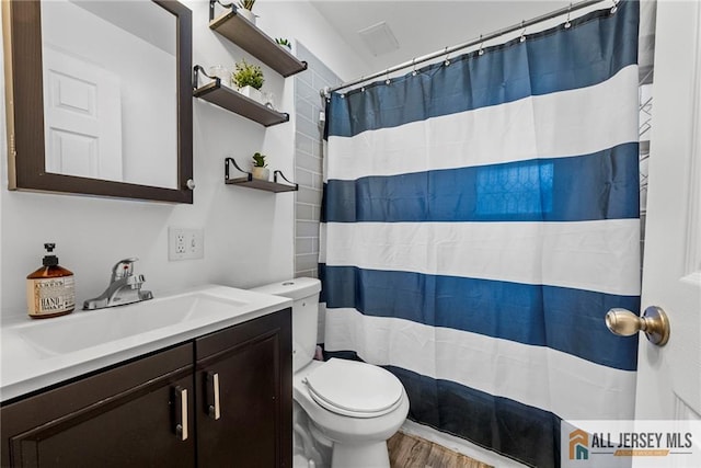 43 Livingston Ave, Avenel, NJ 07001 - bathroom with wood finished floors, toilet, a shower with shower curtain, and vanity