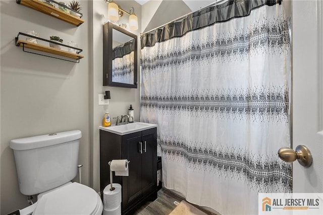 43 Livingston Ave, Avenel, NJ 07001 - full bath with toilet, vanity, wood finished floors, and a shower with shower curtain