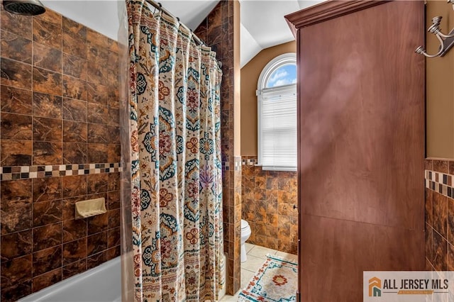 2124 Orchard Dr, South Plainfield, NJ 07080 - full bath featuring toilet, shower / bathtub combination with curtain, a wainscoted wall, tile walls, and lofted ceiling