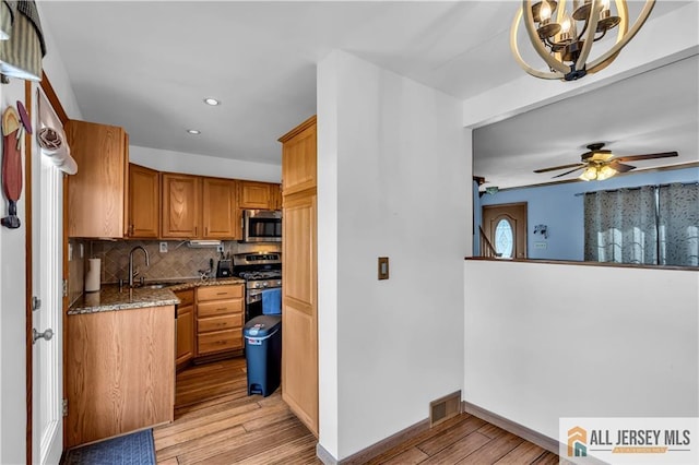 2124 Orchard Dr, South Plainfield, NJ 07080 - kitchen featuring appliances with stainless steel finishes, light wood finished floors, stone countertops, recessed lighting, and backsplash