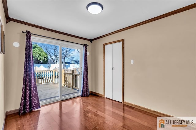 2124 Orchard Dr, South Plainfield, NJ 07080 - doorway to outside featuring crown molding, baseboards, and wood finished floors