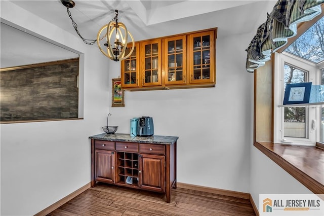 2124 Orchard Dr, South Plainfield, NJ 07080 - bar with baseboards, a chandelier, pendant lighting, and dark wood-type flooring