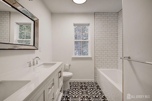 full bath with a sink, tile patterned flooring, toilet, and double vanity