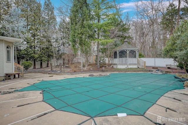 view of swimming pool with a patio area, a gazebo, fence, and a fenced in pool