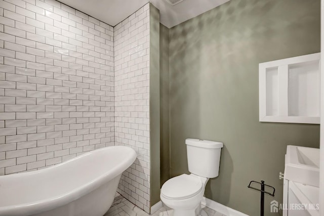 full bath featuring a freestanding bath and toilet