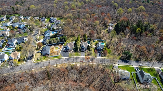 birds eye view of property featuring a forest view and a residential view