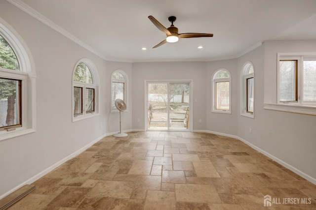 interior space with ornamental molding, baseboards, ceiling fan, and stone tile flooring