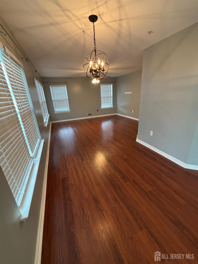 1057 Morning Glory Dr, Monroe, NJ 08831 - spare room featuring a chandelier, baseboards, and dark wood-style flooring