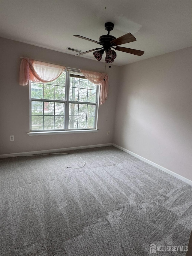 1057 Morning Glory Dr, Monroe, NJ 08831 - empty room featuring healthy amount of natural light, ceiling fan, carpet flooring, and baseboards