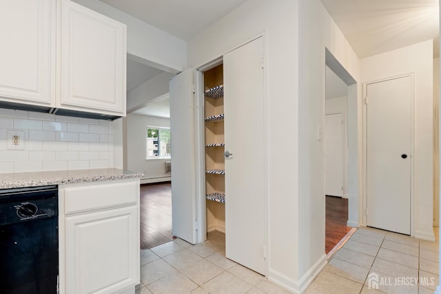 18 Lake Ave Unit 8A, East Brunswick, NJ 08816 - kitchen with black dishwasher, light tile patterned floors, tasteful backsplash, light stone countertops, and white cabinets