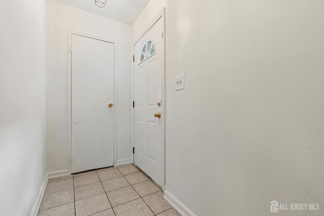 18 Lake Ave Unit 8A, East Brunswick, NJ 08816 - doorway with baseboards and light tile patterned flooring