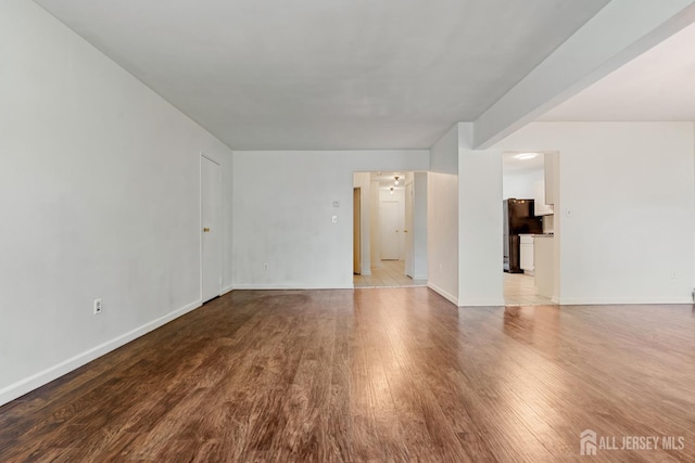 18 Lake Ave Unit 8A, East Brunswick, NJ 08816 - unfurnished living room featuring wood finished floors and baseboards