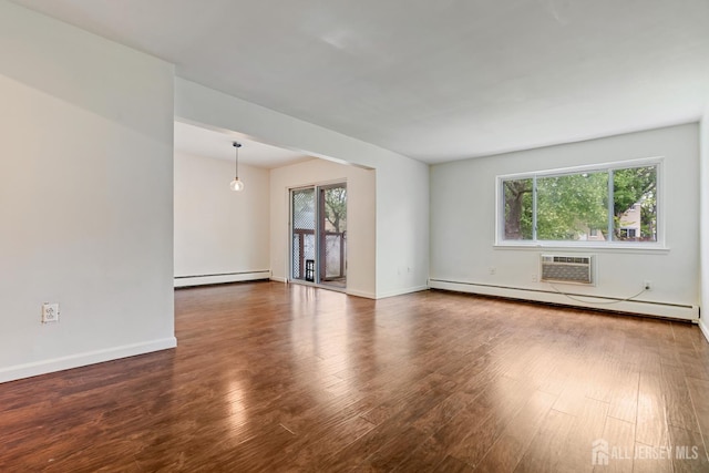 18 Lake Ave Unit 8A, East Brunswick, NJ 08816 - spare room with a baseboard heating unit, wood finished floors, and a wall mounted air conditioner