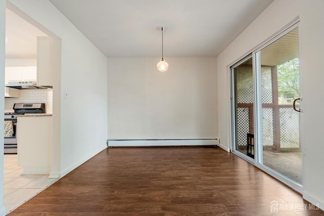 18 Lake Ave Unit 8A, East Brunswick, NJ 08816 - unfurnished dining area featuring baseboard heating and wood finished floors