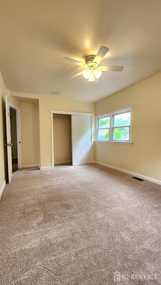 20 Brunswick Ave, Spotswood, NJ 08884 - unfurnished bedroom featuring light carpet, a closet, and ceiling fan