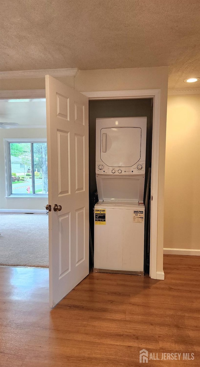 20 Brunswick Ave, Spotswood, NJ 08884 - laundry room featuring stacked washer / drying machine, a textured ceiling, light wood-type flooring, and recessed lighting