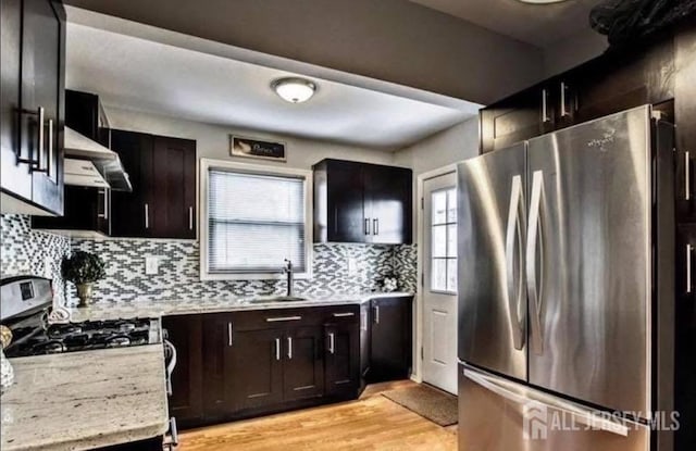 54 Washington Rd, Sayreville, NJ 08872 - kitchen with stainless steel appliances, wall chimney range hood, a sink, light wood-style flooring, and backsplash
