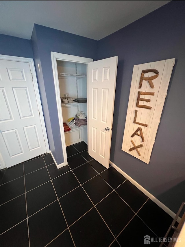 54 Washington Rd, Sayreville, NJ 08872 - bedroom with dark tile patterned flooring, baseboards, and a closet