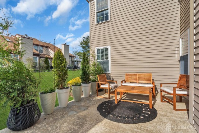 view of patio / terrace featuring fence and an outdoor living space
