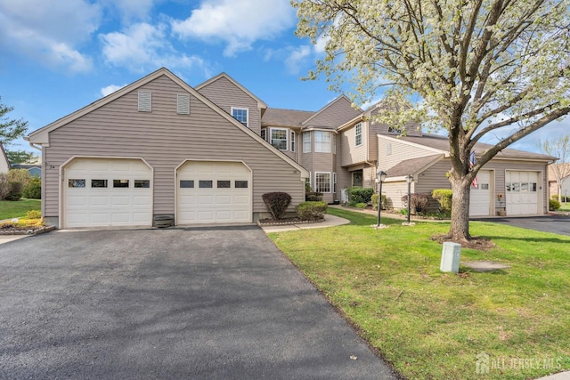 traditional-style home with a front lawn and aphalt driveway