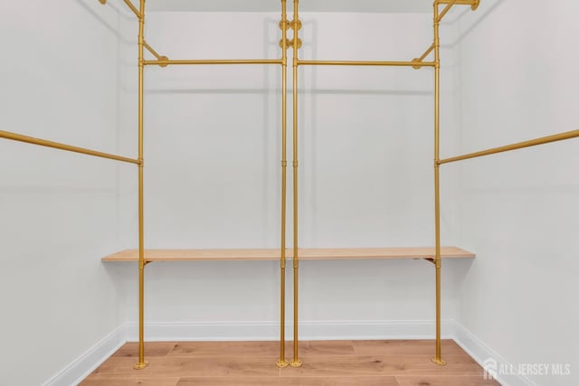 spacious closet with wood finished floors