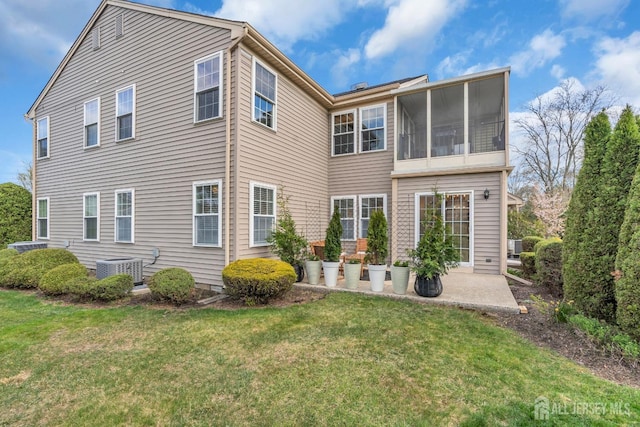 back of house with a yard, central AC unit, and a patio