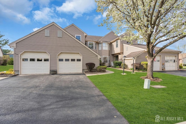 traditional-style house with driveway and a front yard