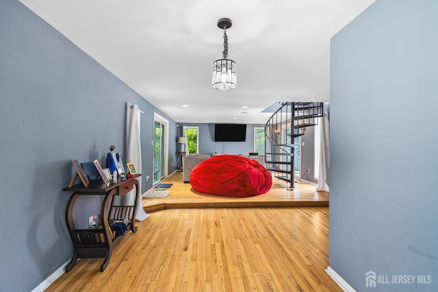 76 Woodland Dr, Keyport, NJ 07735 - hallway featuring stairs, wood finished floors, baseboards, and a chandelier