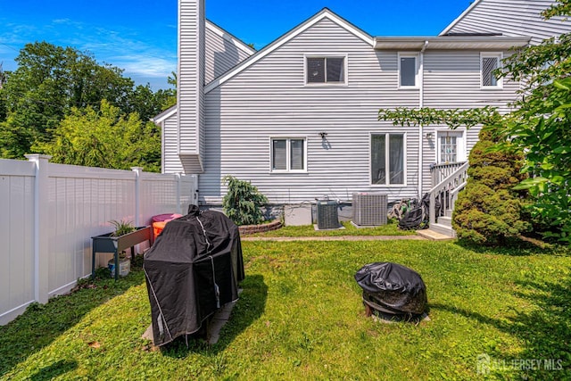 76 Woodland Dr, Keyport, NJ 07735 - back of property featuring a fire pit, a chimney, and cooling unit