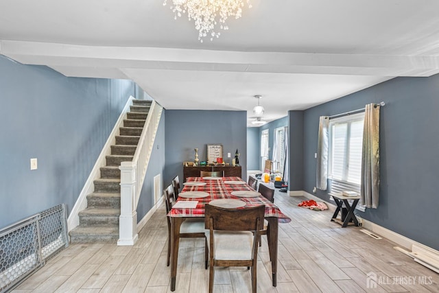 76 Woodland Dr, Keyport, NJ 07735 - dining room with stairs, light wood-style flooring, a chandelier, and baseboards