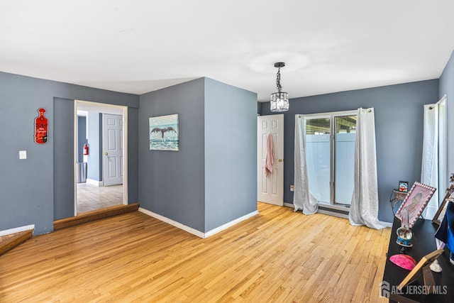 76 Woodland Dr, Keyport, NJ 07735 - unfurnished dining area with wood finished floors, baseboards, and a chandelier