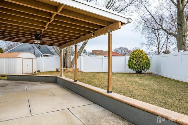 view of patio featuring a fenced backyard, a storage unit, and an outdoor structure